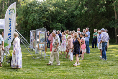 Patrons enjoying a sneak peek of the plein air competition paintings at the Patron Preview Party.
