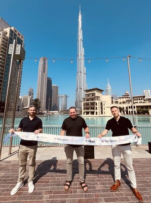 Christian Schnedler, Graham Westbrook, and Jason Rivera hold a ribbon-cutting in Dubai, United Arab Emirates