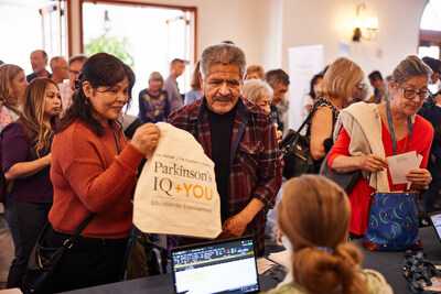 Parkinson's IQ + You event participants are welcomed to the event by MJFF staff members.