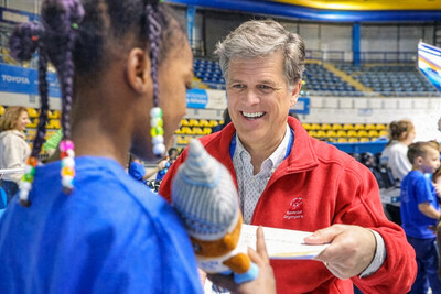 Special Olympics Chairman Dr. Timothy Shriver presents a certificate to a young athlete, celebrating their achievement during the Young Athletes event at the Special Olympics World Winter Games Turin 2025.