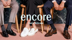 Three professionally dressed people seated side by side on wooden chairs with the Encore logo and “You’re Welcome” overlaid.