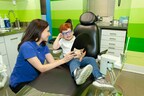 Pediatric Dentist Dr. Sara Babich explaining dental procedure to the red boy