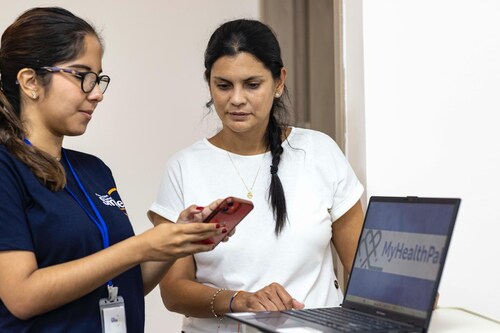 A Global Smile Foundation team member works with a family to support postoperative follow-up using the MyHealthPal app. A Global Smile Foundation team member works with a family to support postoperative follow-up using the MyHealthPal app.