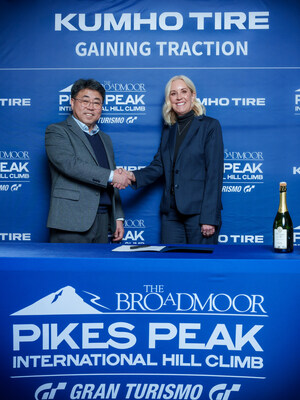 John Yoon, Kumho Tire U.S.A senior vice president of marketing, and Melissa Eickhoff, CEO of the Pikes Peak Hill Climb, at a signing ceremony for the new Kumho Tire Gaining Traction Program on January 28, 2026.