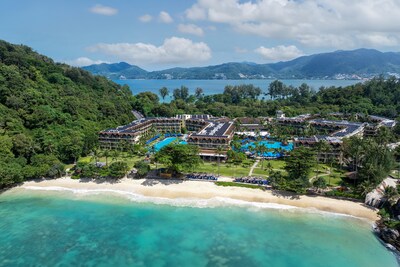 Aerial view of Phuket Marriott Resort & Spa, Merlin Beach, showcasing its expansive beachfront property with lush greenery, multiple swimming pools, and solar panel-equipped buildings along the turquoise coastline