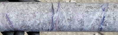 Figure 2: Pollucite with late stage lepidolite (purple) and spodumene/pollucite (white) veining displaying classic &ldquo;tapioca&rdquo; texture (white blebs) at a depth of ~126 m in drill hole CV25-948 from the Vega Zone. Core grades 1.9 m at 17.81% Cs2O (125.0 m to 126.9 m) within a wider mineralized interval of 28.0 m at 8.05% Cs2O (116.5 m to 144.5 m) (CNW Group/PMET Resources Inc.)