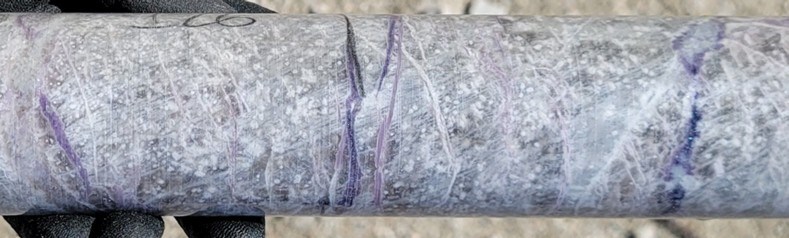 Figure 2: Pollucite with late stage lepidolite (purple) and spodumene/pollucite (white) veining displaying classic “tapioca” texture (white blebs) at a depth of ~126 m in drill hole CV25-948 from the Vega Zone. Core grades 1.9 m at 17.81% Cs2O (125.0 m to 126.9 m) within a wider mineralized interval of 28.0 m at 8.05% Cs2O (116.5 m to 144.5 m) (CNW Group/PMET Resources Inc.)