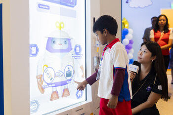 PCF Sparkletots Preschool student interacting with WonderBot 2.0 at the Children’s Museum Singapore