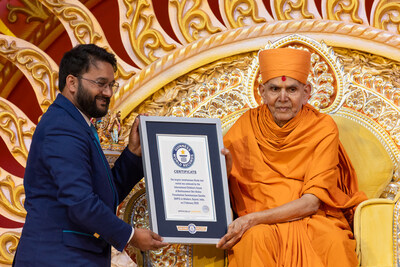 His Holiness Mahant Swami Maharaj is formally presented with a Guinness World Records certificate recognizing the largest simultaneous recitation of a Hindu text, achieved by 12,723 children reciting Sanskrit verses from the Satsang Diksha in Gujarat, India.