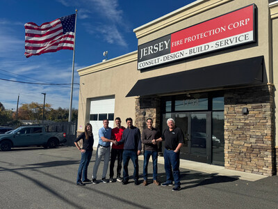 Representatives from Pye-Barker Fire & Safety and Jersey Fire Protection Corp celebrate the acquisition at Jersey Fire's West Deptford, New Jersey headquarters. The partnership combines Jersey Fire's regional expertise in fire sprinkler systems with Pye-Barker's nationwide resources to enhance fire protection services across the Mid-Atlantic region.
