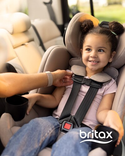 A caregiver adjusts the harness on a rear-facing child seated in the Britax Galaxy360™.