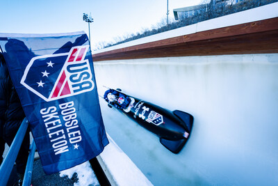 The USA Bobsled team passes a fan on a recent run during their 2025-26 season.