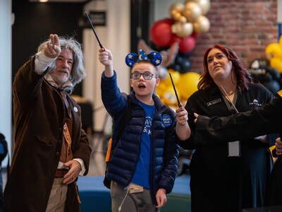 A character inspired by Ollivander welcomed Keyton beside a wand display case and presented him with a custom wand created just for him.