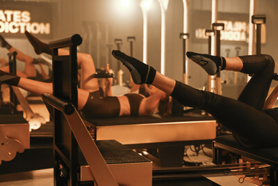 Pilates Addiction showcasing modern design, mood lighting, and gold machines