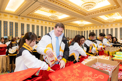 Patrick Dumont (second from left), president and chief operating officer of Las Vegas Sands, together with the company’s management team, participates in assembling Chinese New Year festive kits Feb. 3. The team worked together to assemble more than 20,000 staple foods and essential items. (PRNewsfoto/Sands China Ltd.)