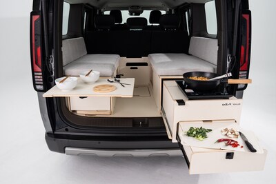 VanLab - Tailgate kitchen and rear dining. Pull out drawers reveal the exterior kitchen all under the cover of the tailgate roof. Allowing for effortless food prep and elevated outdoor dining. Using the vehicle V2L allows for electric hot plate and electric fridge use to allow for a proper meal to be enjoyed under the stars.