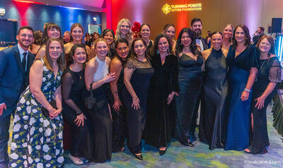 Turning Pointe Autism Foundation Executive Director Carrie Provenzale (center, in a long-sleeve black dress) is joined by her team as she thanks supporters during the Chicago Auto Show’s First Look for Charity at McCormick Place in Chicago. The foundation welcomed 250 guests to a pre-gala reception prior to the event and raised more than $130,000.