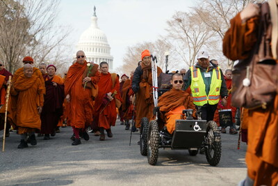 Unbroken Spirit: Bhante Dam Phommasan rolls toward the U.S. Capitol, completing the journey he started on foot. After losing his leg in a traffic accident in Texas during the walk, he famously described the loss as an 