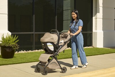 Parent pushes a Britax Juniper+ compact stroller featuring an infant car seat securely attached to the stroller frame, highlighting seamless compatibility and smooth maneuverability for everyday outings. (adapters and infant seat sold separately)