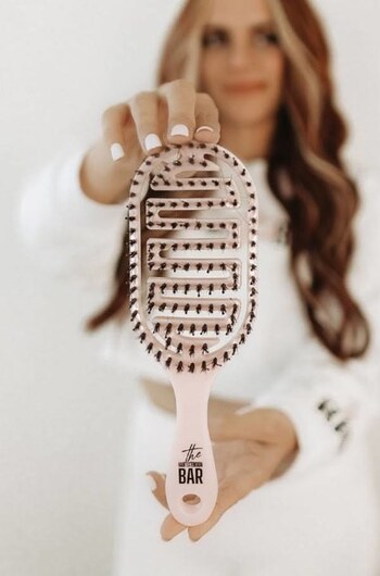 The Hair Extension Bar branded hairbrush.