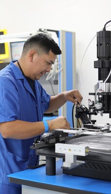 Technician specializing in repairs utilizing a ball grid array (BGA) rework station.