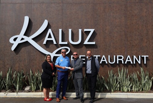 Kaluz Restaurant General Manager Ryan Perez presents a $7,500 donation check to South Broward Foundation leaders Patricia Archer, Mike Ross, and Ken Rivera.