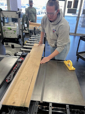 As more people look for a break from screen-heavy days, woodworking provides a clear and hands-on outlet. Here a woodworker carefully rips a board on a table saw during a class at the Woodcraft store in Chattanooga, Tenn.