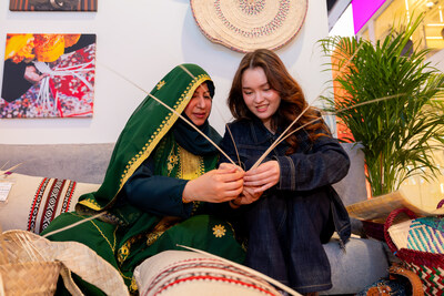 Visitors at the Saudi Pavilion take part in a traditional Saudi weaving experience at ITB Berlin 2026