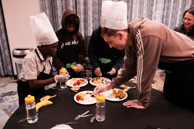 Maine Celtics player Hank Morgan creates healthy snacks with middle schoolers from Boys and Girls Clubs of Southern Maine at Residence Inn, Portland.