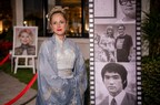 A traditional kimono-clad hostess stands beside memorable film stills of Chin and Lee