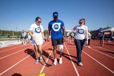 Full Circle Movement volunteers support a participant with mobility drills.