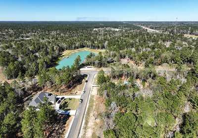 Aerial view of the model home village at The Estates of Texas Grand Ranch, featuring a Design Tech Homes model home near the Sam Houston National Forest north of Houston.
