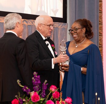 Jenniffer Gordon, lead aid at Sturges Ridge of Fairfield, accepts Benchmark's 2025 Called to Care Award for Compassionate Caregiving