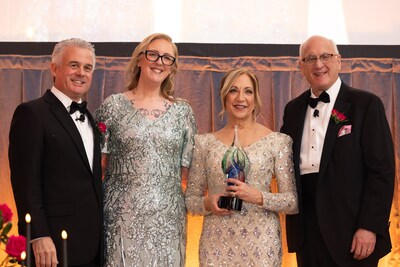 Anne DeMinico, executive director of The Village at Willow Crossings, accepts the 2025 One Company Fund award