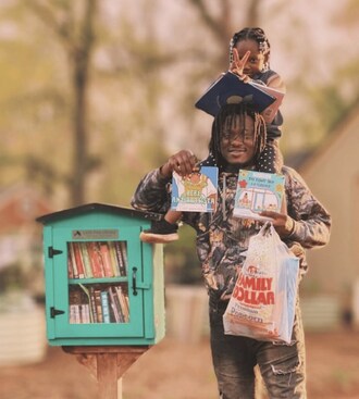 Neighbors visit Sima Hill's Little Free Library—granted by the the LFL nonprofit's Impact Library Program—in Decatur, Georgia.