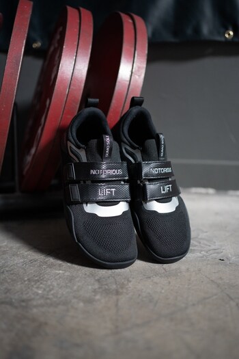 Sumo Sole Gen 5 - Stealth leaning on weight rack