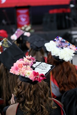 University of Phoenix graduates shown with decorated mortarboards at the 2026 Spring commencement ceremony at Chase Field in Phoenix on March 7, 2026.