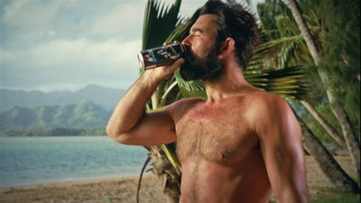 Mike drinks a Bucked Up® Rocket Pop energy drink on the beach in a still from the Bucked Up® Castaway commercial. Mike drinks a Bucked Up® Rocket Pop energy drink on the beach in a still from the Bucked Up® Castaway commercial.