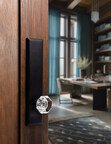 Ageless Iron™ matte black door hardware pairs a faceted crystal knob with a tall architectural plate, showcasing mixed-material design.