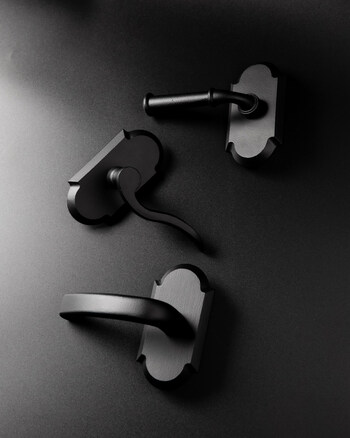 Three sculptural matte black levers—Cannon, Crescent, and Palisade—explore form and movement, bringing bold architectural expression to modern door hardware.