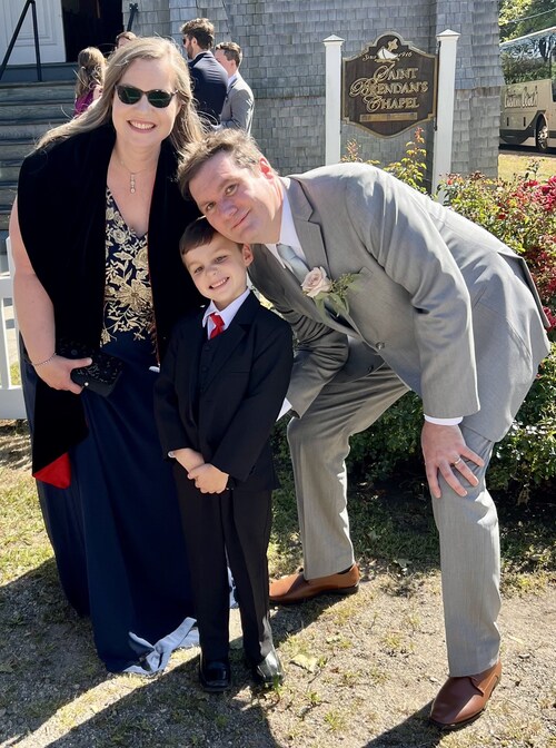 Educator Gavin Roddy poses with his wife and son.