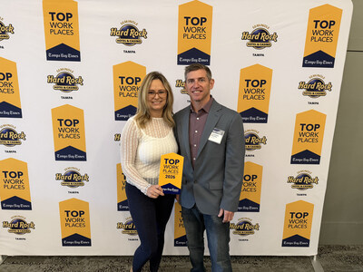 Holly Daigneault - VP of Operation and Joe Ravens - Head of Customer Service accepting the Top Work Places Award on behalf of Byzfunder