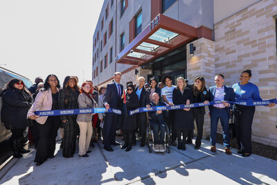 HELP USA Dan Lehman (center) cuts ribbon at newest women's shelter in Brooklyn.