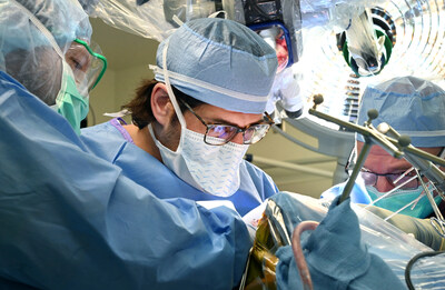 Dr. Kramer places the first of several pedestals onto the surface of the patient's brain. A wire from the pedestal will connect to the computer interface array at the cortex. Photo by Sonya Doctorian at UCHealth, University of Colorado Hospital