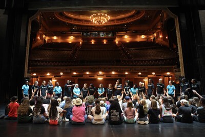 Students gather on stage at the Hippodrome Theatre as part of an education program connected to SUFFS: The Musical, which will engage Baltimore-area youth in learning about civic activism, voting, and the women’s suffrage movement.