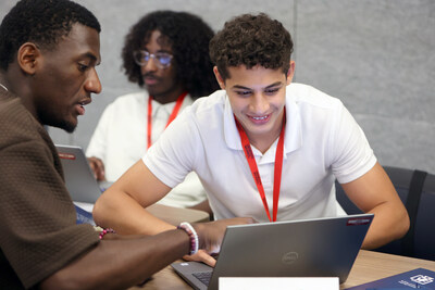 A Genesys Works trainer guides a student through technical training, building the skills and workplace readiness needed to succeed in a year-long paid corporate internship. A Genesys Works trainer guides a student through technical training, building the skills and workplace readiness needed to succeed in a year-long paid corporate internship.