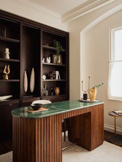 Herringbone oak flooring, soaring high ceilings, and expansive windows set the tone throughout.