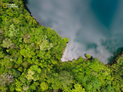 Drone image of the nearby cenote in Sierra del Lacandon National Park, Peten, Guatemala. Photo by Omar Alcover/National Geographic.