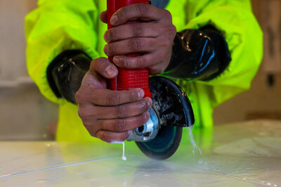 Un trabajador utiliza una herramienta manual para cortar en húmedo una encimera de piedra artificial en un taller de fabricación. Foto de Semantha Raquel Norris. (PRNewsfoto/Brayton Purcell LLP)