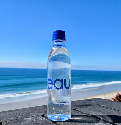 Eau Vodka’s lightweight, portable bottle shown in a coastal San Diego setting, highlighting its water-inspired design and on-the-go use